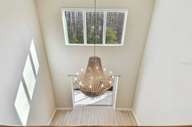 details with hardwood / wood-style floors and a chandelier