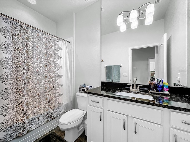 bathroom featuring curtained shower, toilet, and vanity