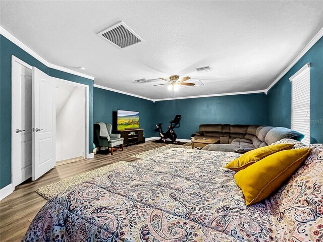 living room with a textured ceiling, ceiling fan, ornamental molding, and hardwood / wood-style floors