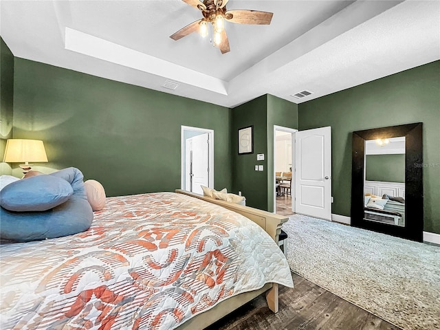 bedroom with ceiling fan and dark hardwood / wood-style flooring