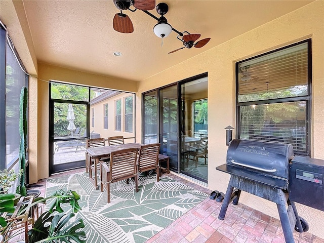 sunroom featuring ceiling fan