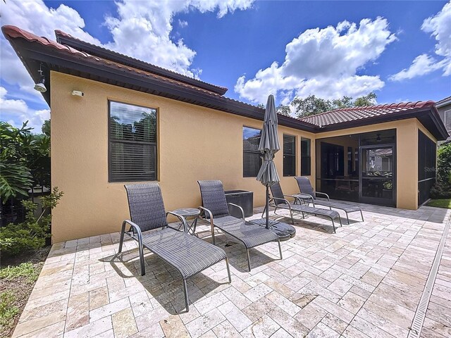 view of patio featuring a sunroom