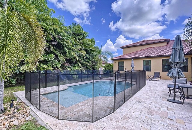 view of swimming pool with a patio area