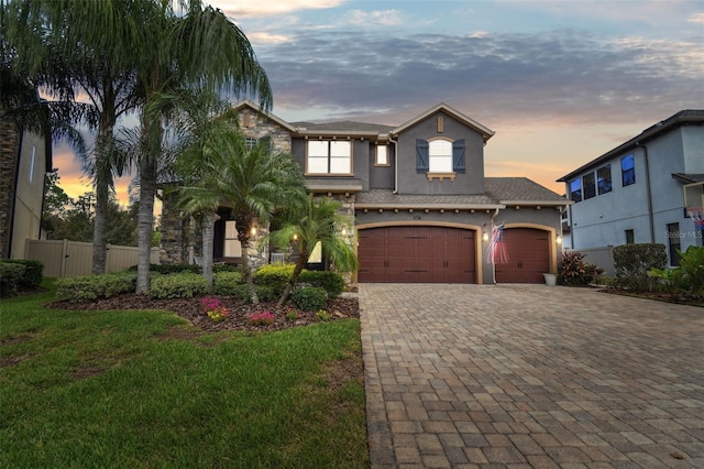 view of front facade featuring a garage and a yard