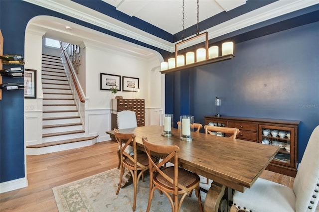 dining space featuring ornamental molding and light hardwood / wood-style floors