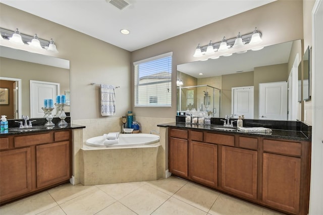 bathroom featuring tile patterned flooring, vanity, and plus walk in shower