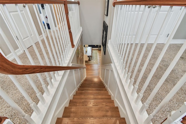 staircase with hardwood / wood-style floors