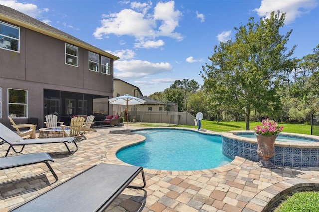 view of swimming pool with an in ground hot tub, a patio area, and an outdoor fire pit