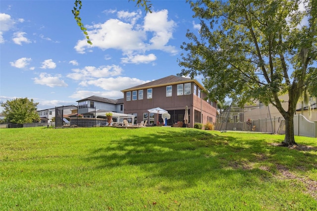 rear view of property with a lawn