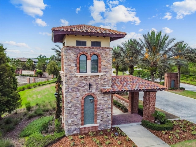 mediterranean / spanish-style house featuring a front lawn