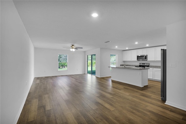 unfurnished living room featuring dark hardwood / wood-style flooring, sink, and ceiling fan