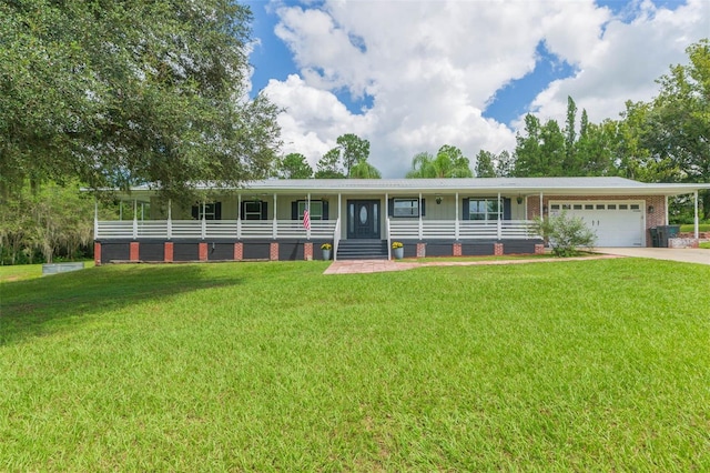 view of front facade with covered porch, a garage, and a front lawn