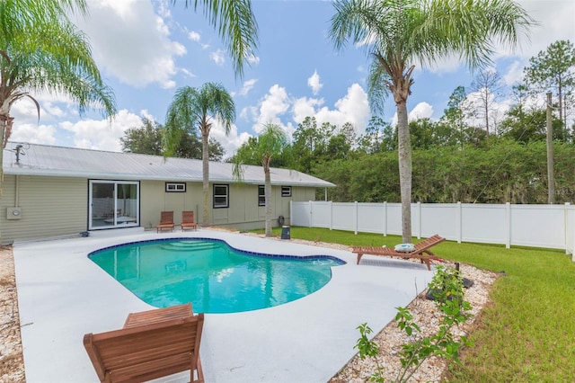 view of pool with a lawn and a patio area