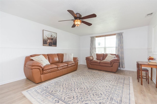 living room with light wood-type flooring and ceiling fan