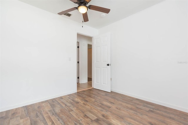 spare room with wood-type flooring and ceiling fan