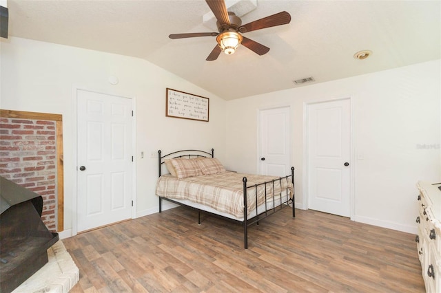 bedroom with lofted ceiling, hardwood / wood-style flooring, and ceiling fan