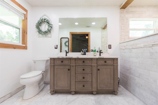 bathroom with vanity, toilet, and plenty of natural light