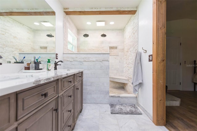 bathroom featuring tiled shower, vanity, and hardwood / wood-style flooring