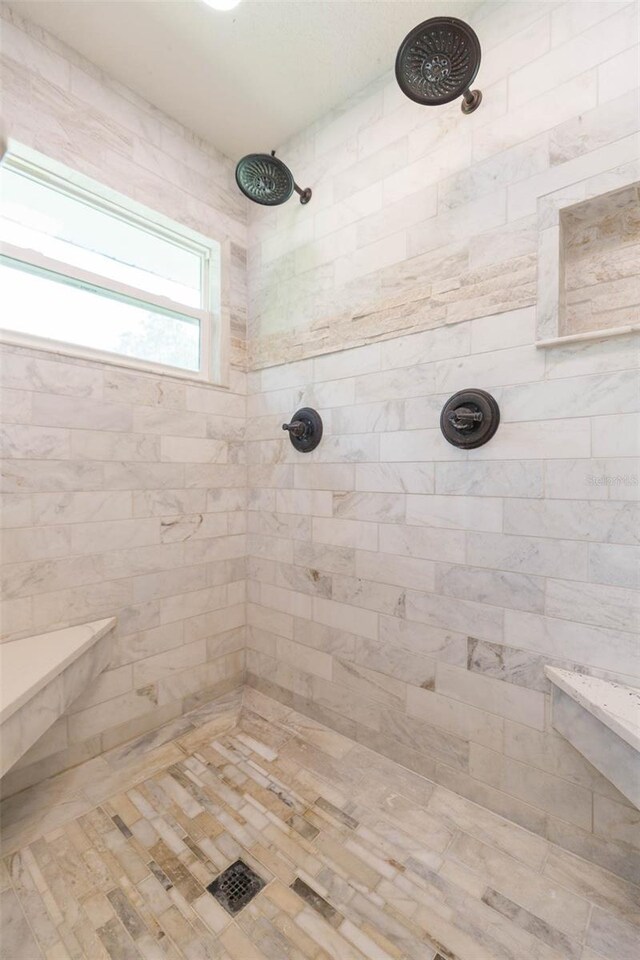 bathroom with tiled shower