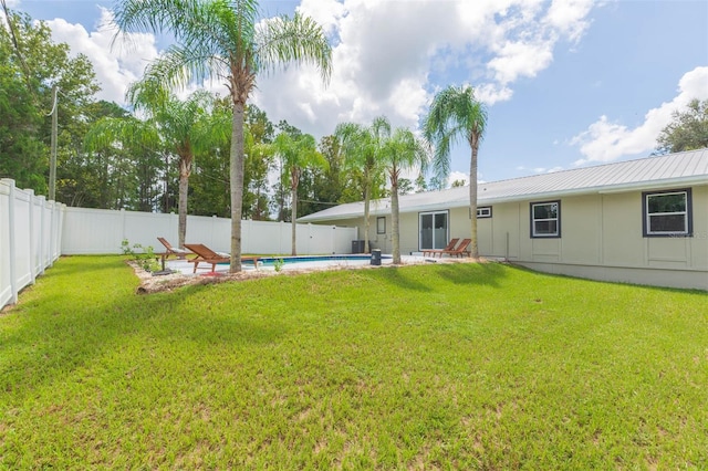 view of yard with a fenced in pool