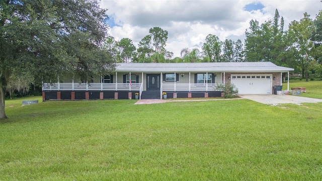 single story home with a front yard, covered porch, and a garage