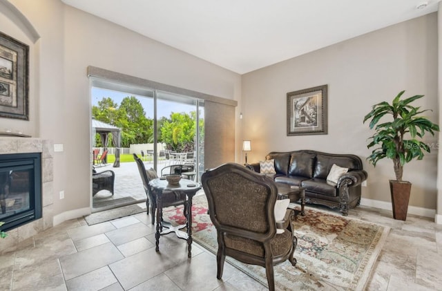 living room with a tiled fireplace