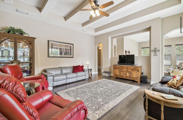 living room featuring dark wood-type flooring, ceiling fan, and beam ceiling