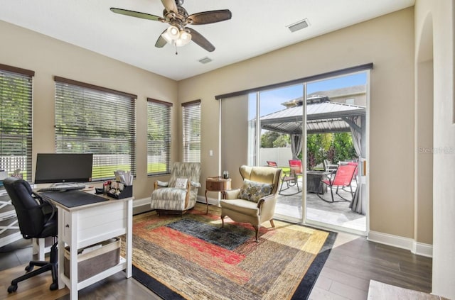 home office featuring ceiling fan and dark hardwood / wood-style floors