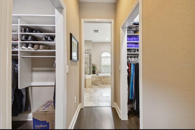 corridor with dark hardwood / wood-style flooring