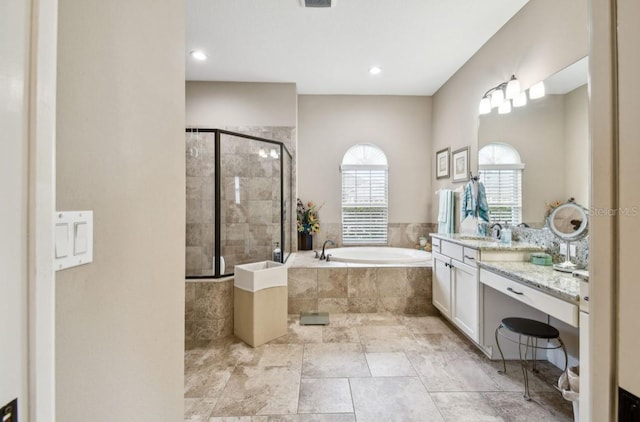 bathroom with independent shower and bath and vanity