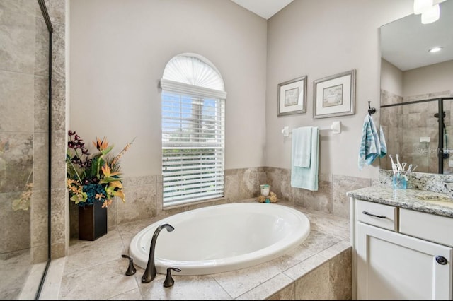 bathroom featuring vanity and plus walk in shower