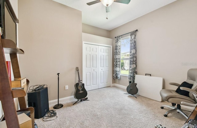 carpeted office featuring ceiling fan