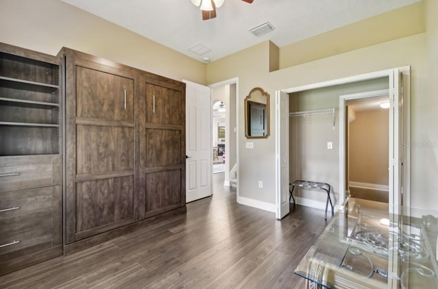 interior space featuring ceiling fan and dark hardwood / wood-style flooring