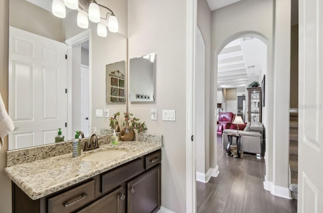 bathroom featuring vanity, hardwood / wood-style flooring, and beam ceiling