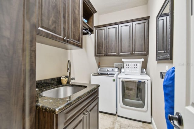 laundry room featuring washer and dryer, cabinets, and sink