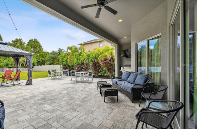 view of patio / terrace with an outdoor hangout area, ceiling fan, and a gazebo