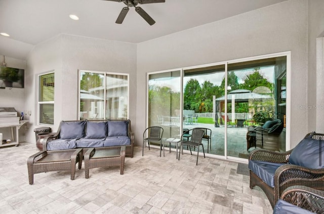 sunroom / solarium featuring ceiling fan