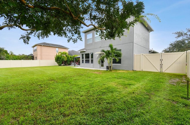 rear view of house featuring a lawn