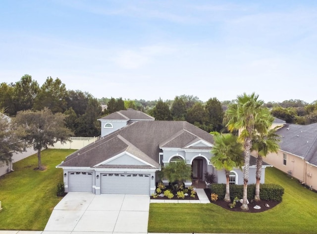 view of front of property with a garage and a front yard