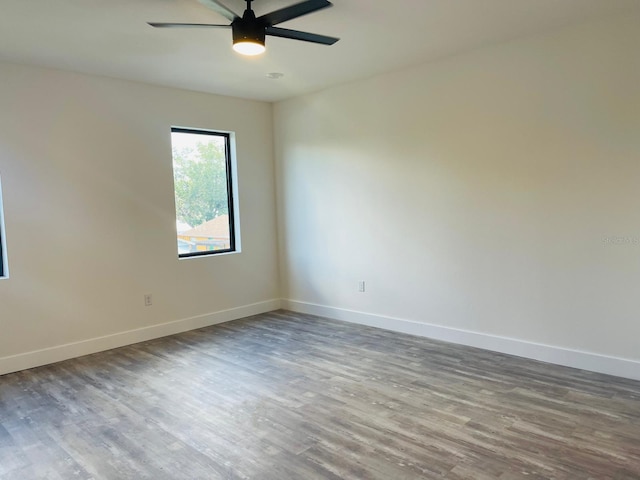 empty room featuring hardwood / wood-style floors and ceiling fan