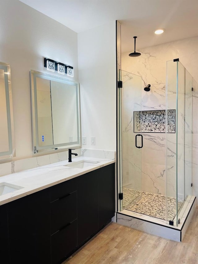 bathroom featuring vanity, an enclosed shower, and hardwood / wood-style flooring