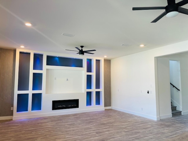 unfurnished living room with hardwood / wood-style floors and ceiling fan