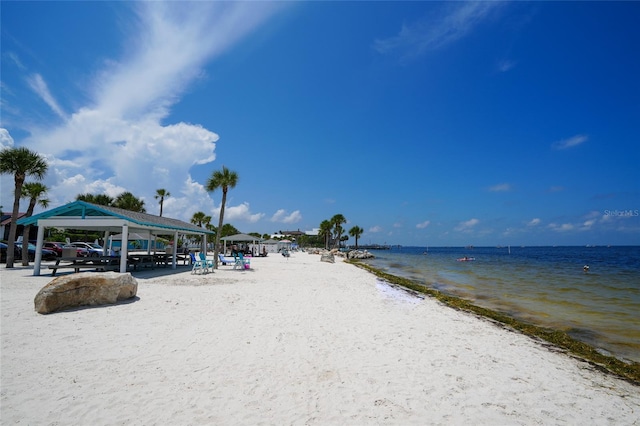 property view of water featuring a gazebo and a beach view