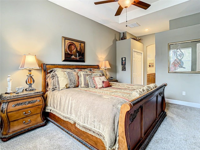 carpeted bedroom featuring ensuite bathroom, ceiling fan, and a closet