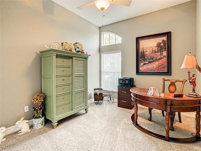 office area featuring ceiling fan, light carpet, and vaulted ceiling