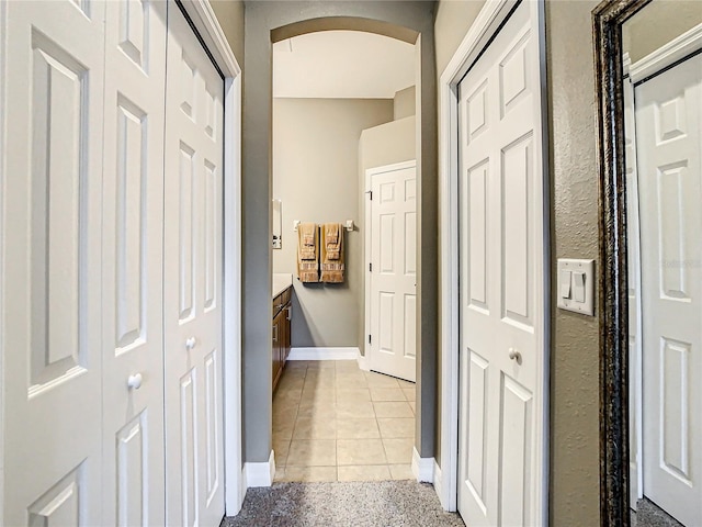 hallway with light tile patterned floors