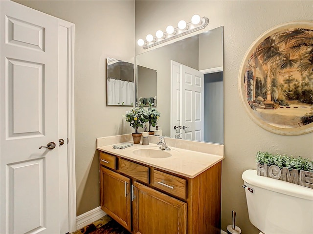 bathroom with toilet and vanity