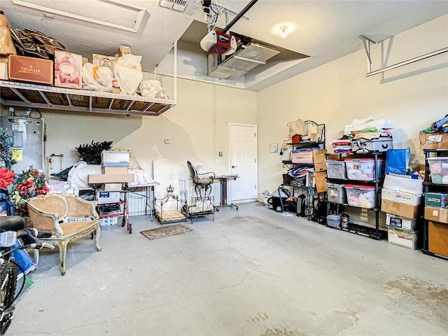 garage featuring electric water heater and a garage door opener