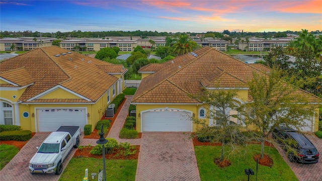 4737 Casswell Dr, New Port Richey, FL 34652 - view of front of house with a tiled roof, decorative driveway, a garage, and stucco siding