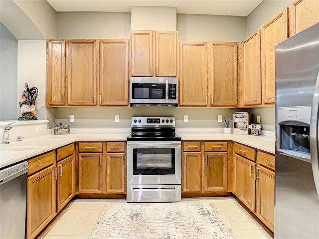 4737 Casswell Dr, New Port Richey, FL 34652 - kitchen featuring appliances with stainless steel finishes, light countertops, light tile patterned flooring, and a sink